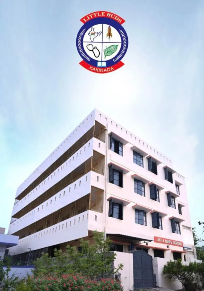 The Little Buds school building in Indrapalem, Kakinada — a multi-storey block with the school crest on the façade, seen from the road.